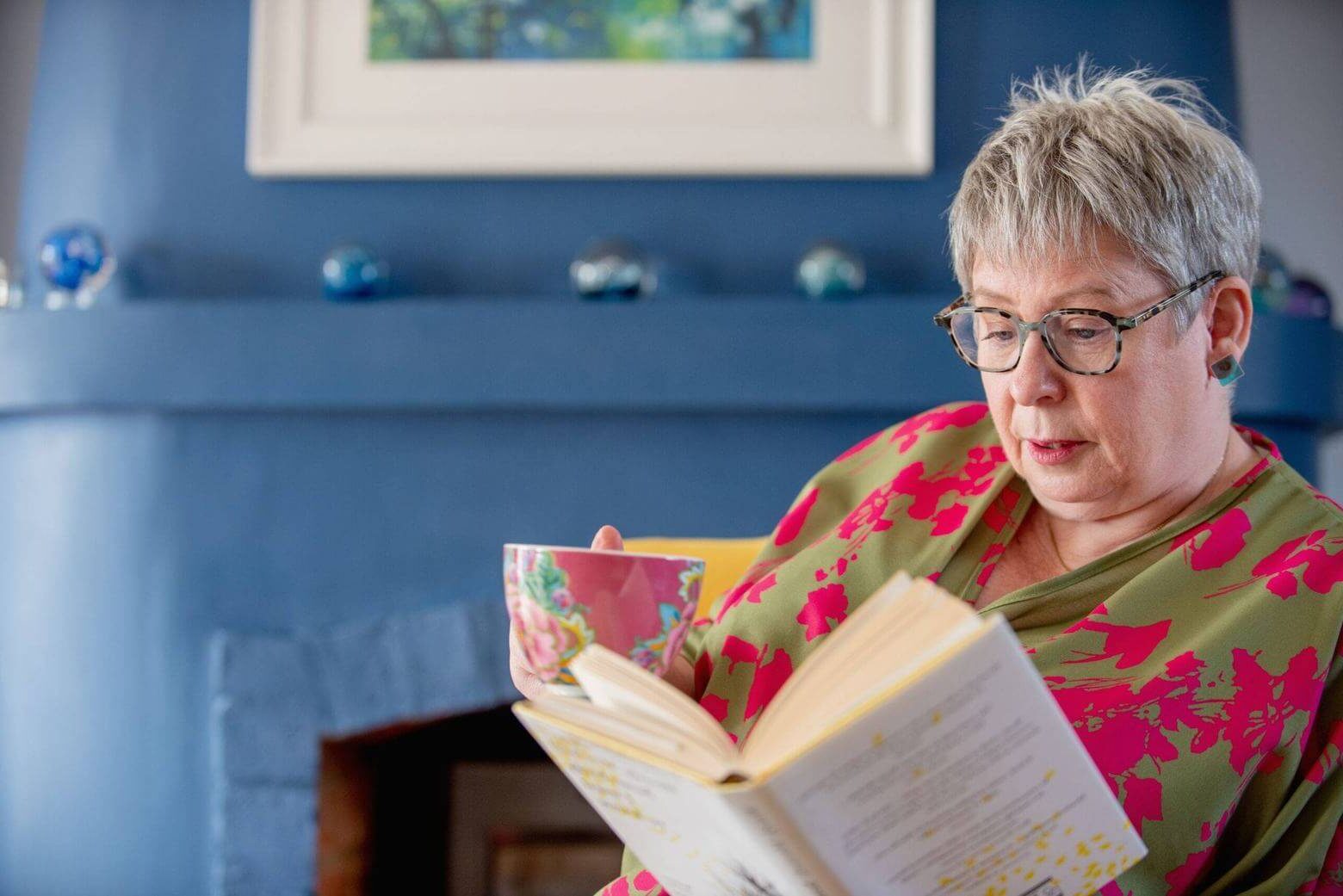 Dr Carol Sargent reading a book by Wendy Mitchell